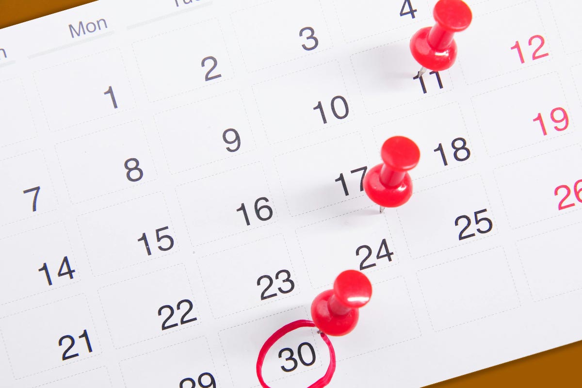 Calendar with red tacks